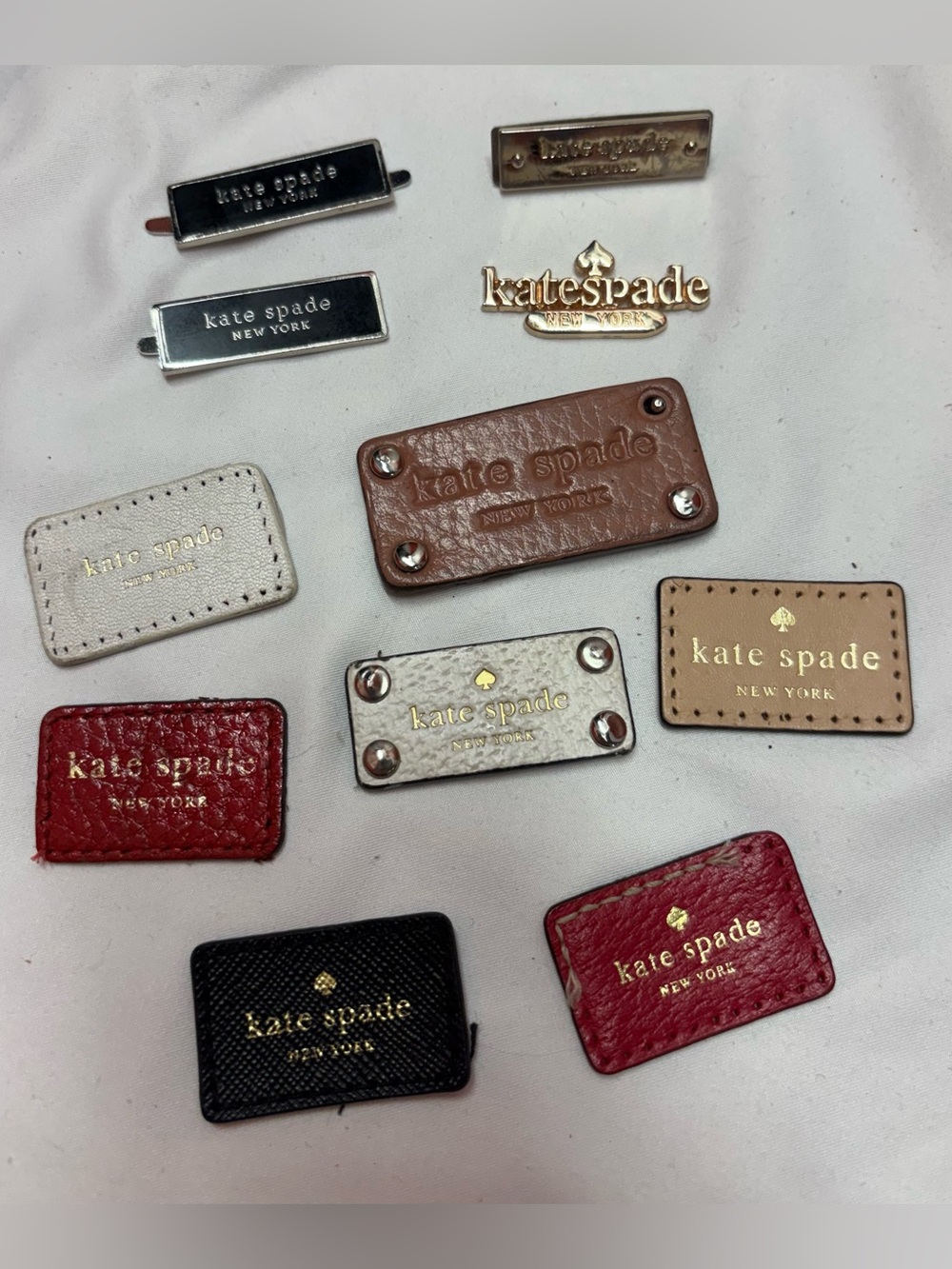 kate spade Silver/Gold Metal Logo Plates AND Assortment of Leather Logos